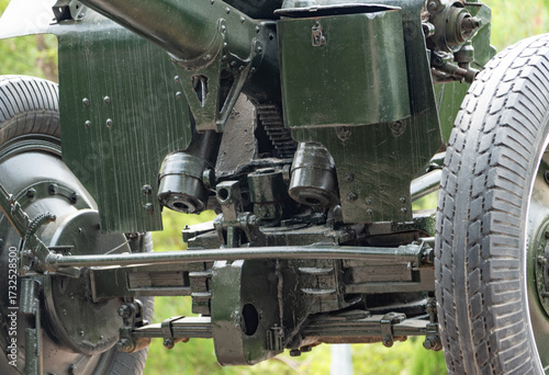 Close-up of the lower part of a Soviet gun with mechanisms, suspension, and wheels, highlighting structural details.