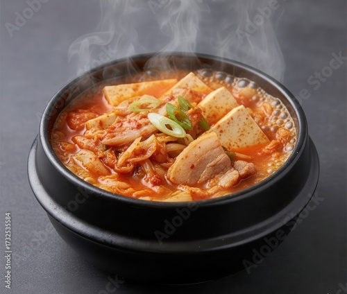 Kimchi Stew Kimchi Jjigae (김치찌개) Boiling in a Black Stone Pot, Warm Light
