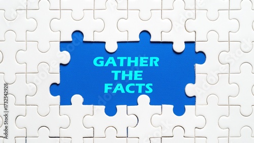 Photography concept of GATHER THE FACTS writing in the middle of a puzzle isolated on a blue background