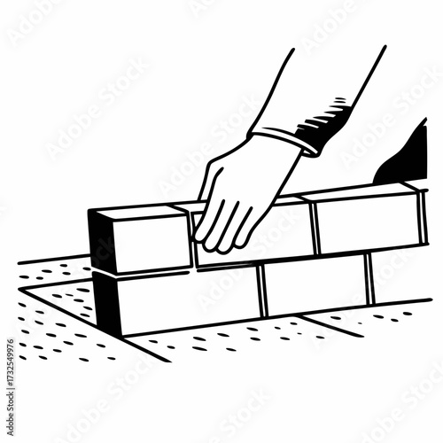 Construction worker placing brick on floor during building process  