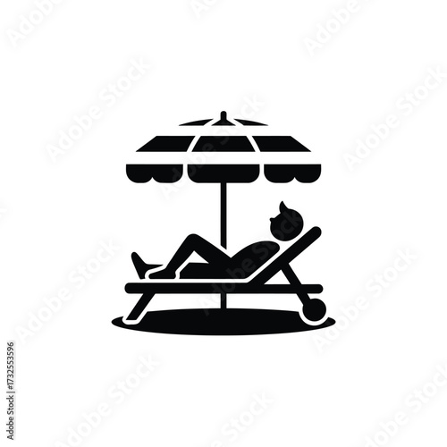 Person relaxing on a lounge chair under a striped umbrella