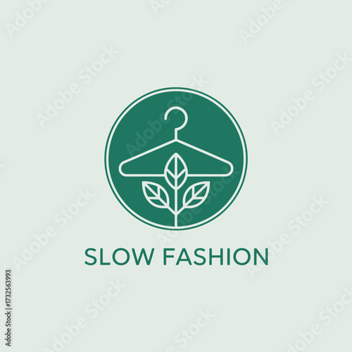 This logo represents the principle of slow fashion, featuring a hanger intertwined with leaves, symbolizing sustainability and thoughtful production in the clothing industry.