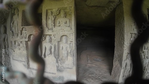 The Rich Texture and Fine Craftsmanship of Ancient Rock-Cut Reliefs Adorning a Wall in the Kanheri Cave Complex, Evoking Spiritual Heritage.