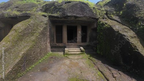 The Historical and Primitive Chamber of a Buddhist Monk within the Kanheri Complex, Featuring Rough-Hewn Walls and Stone Plinths