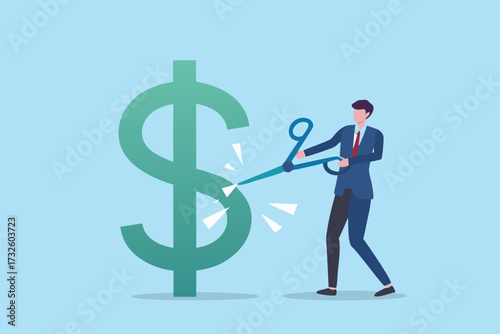 Businessman cutting a large green dollar sign with scissors representing financial cuts or budget reduction