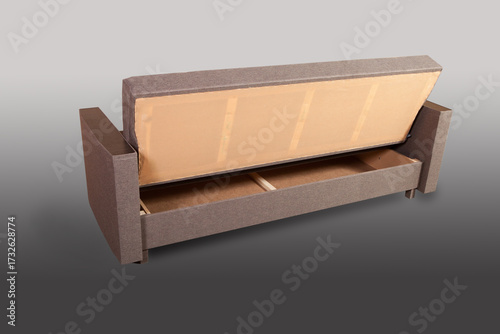 Isolated sofa bed with fabric upholstery on grey gradient background.