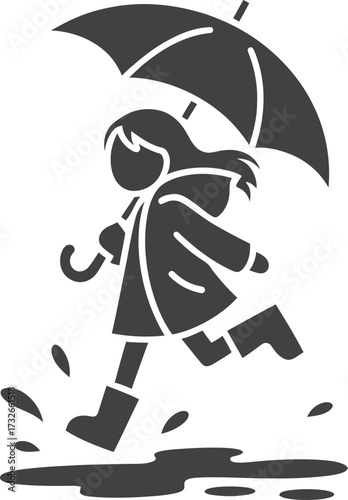 Child in raincoat and boots jumps in puddles under umbrella