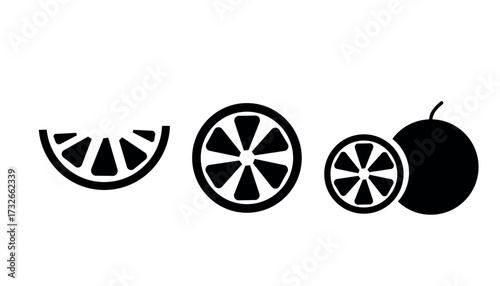 Black and white citrus fruit slices and whole fruit