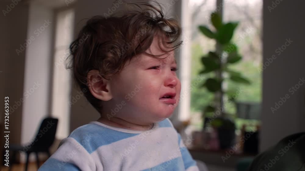 Baby crying with tears rolling down cheeks, emotional expression of ...