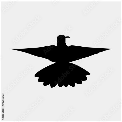 This is a silhouette of a bird with its wings spread wide, creating a sense of freedom and flight. The bird's black color contrasts with the white background.