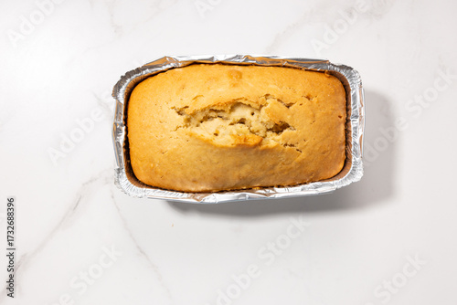 pound cake food in foil baking dish top view concrete surface