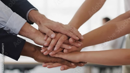 Diverse Hands in Unity for Common Goals - A group of diverse people are shown with their hands stacked on top of each other.