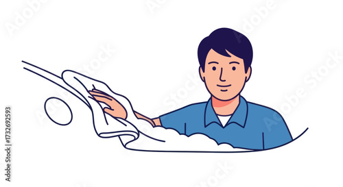 Young man in a blue shirt carefully cleaning a car with a cloth.