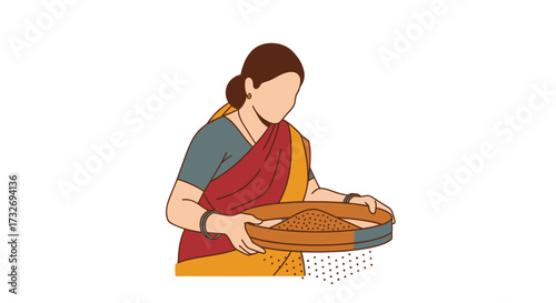 Indian woman in traditional saree cleaning grains with a winnowing fan.