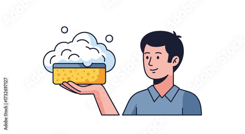 A smiling man holds a yellow sponge with white foam.