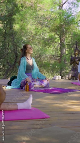 Woman meditating in lotus pose outdoors	