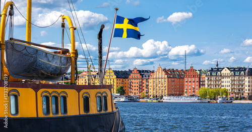 Photography Scenic Harbor View of Stockholm with Swedish Flag and Colorful Buildings