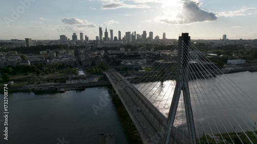 Aerial drone fly-along of Świętokrzyski Bridge with Warsaw city skyline in background, Poland
