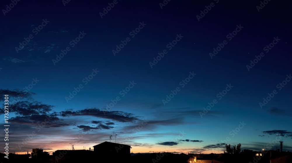 Obraz premium Twilight Sky Over Urban Landscape with Silhouetted Buildings