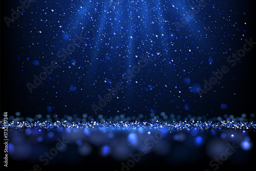 Blue glitter background with sparkles. Shiny metallic particles, glowing light beams, and bokeh effects on dark. Luxury festive scene for celebration, holiday, award design. Vector illustration.