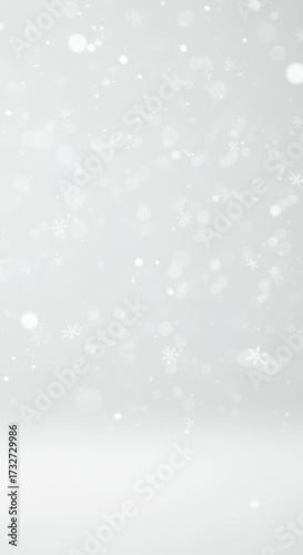 Snowfall on white background creating a serene winter atmosphere  
