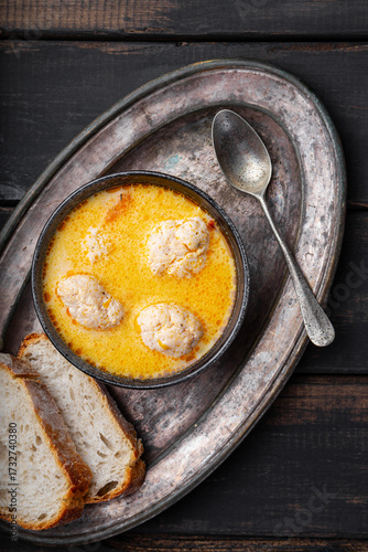 Soup with meatballs, potatoes and cheese on black wooden background. Meatballs in thick vegetable soup Albondigas. Mexican and Spanish, European and Russian cuisine