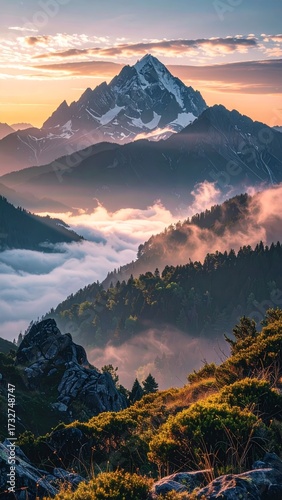 Majestic Mountain Peak Bathed in Golden Sunrise Light Above Misty Valleys.