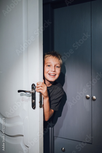 a handsome boy playing hide and seek