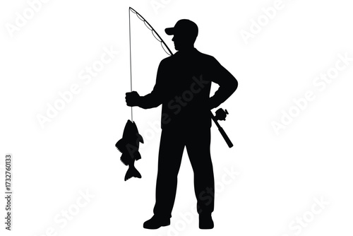 Silhouette of a fisherman holding a caught fish and fishing rod
