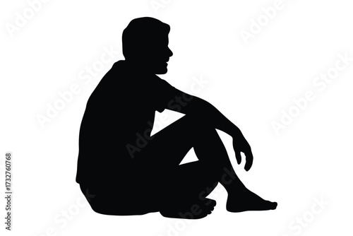 Silhouette of a man sitting down looking to the side