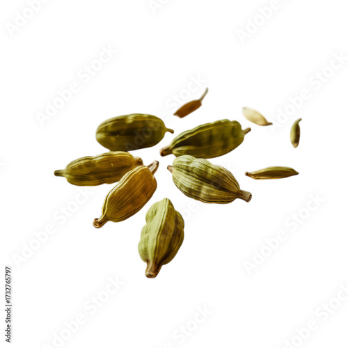 Green cardamom pods scattered on black spice brown