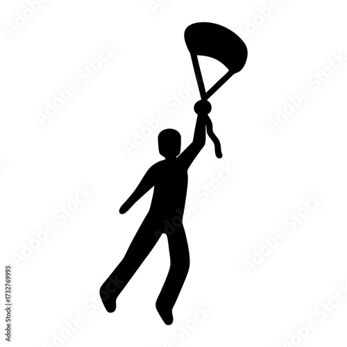Silhouette of a triumphant person holding a parachute high in the air