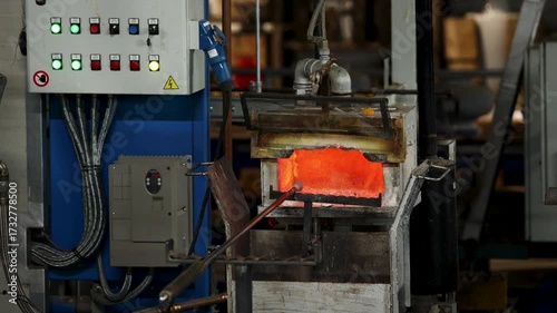 Industrial glassblowing furnaces actively running in glassware factory. Glowing heat of glassmaking process. Handmade blowing glassware design production manufacture Europe