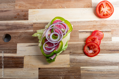 Tableau sur toile Top-down view of diced onion on wooden board – food preparation background