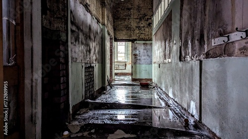 Creepy dark empty hallway interior. Eerie atmosphere corridor light at the end. Peeling paint, warped wet reflective floor. Derelict abandoned deserted hall flooding damage. Natural disaster aftermath