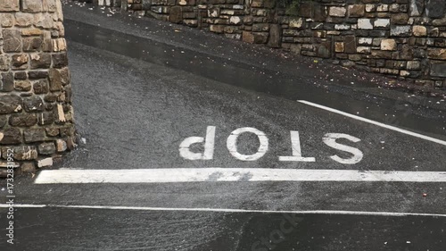  Heavy rain floods the asphalt road, where a 