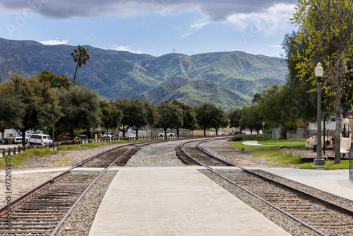 Downtown railroad tracks frame the Santa Susana Mountains in Piru, California, USA.