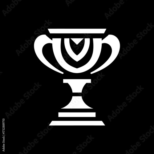 Intricate trophy with decorative handles and pedestal, set against a stark black backdrop