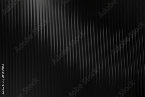 Abstract black corrugated texture background with vertical lines and subtle light creating a dynamic shadow play, ideal for modern design, website backdrops, and digital presentations.