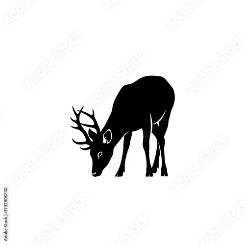 Black silhouette of a deer with antlers grazing