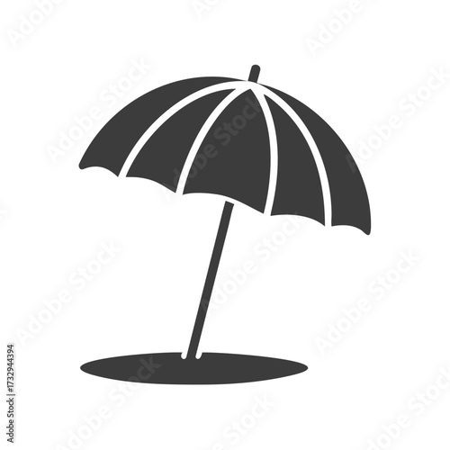 Iconic beach umbrella providing cool shade on a sunny day, perfect for summer vacations and travel promotions