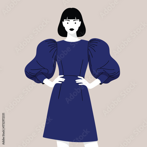 Stylish woman with a black bob haircut in a blue dress with large puffy sleeves.