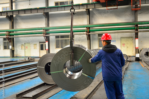 Workers on the production line of the strip steel coil factory are working