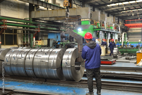Workers on the production line of the strip steel coil factory are working
