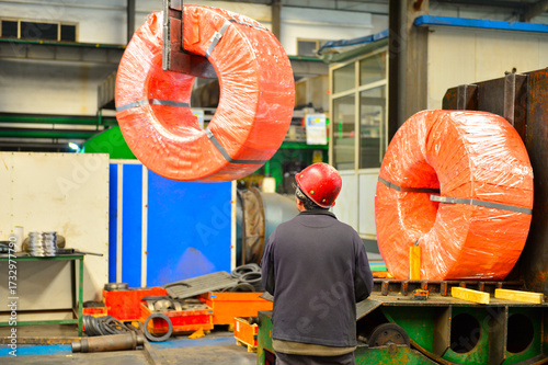 Workers on the production line of the strip steel coil factory are working
