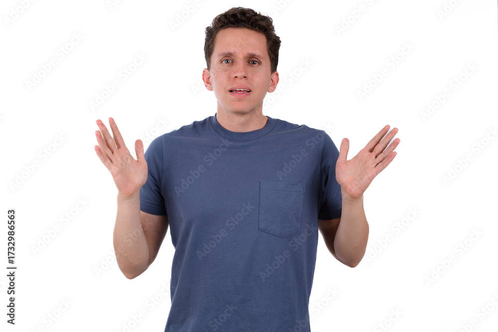 Fototapeta premium Man wearing a blue shirt on a white background making a sign of repulsion, of rejection, of dislike