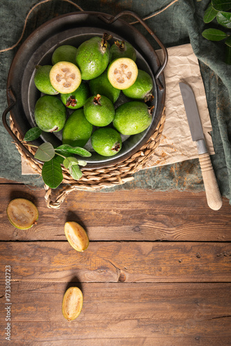 Wallpaper Mural Overhead shot of a rustic still life with ripe pineapple guavas, some cut open to reveal the fleshy pulp, on a small plate and in a basket Torontodigital.ca