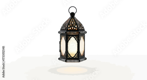 Ornate black metal lantern with soft interior light casting a warm glow on a white surface