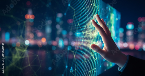 Close up of hand touching digital screen with blurred city lights background
