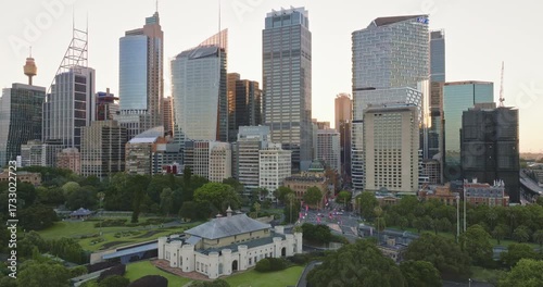 Australia, Sydney: Aerial view Sydney's skyline at sunset, highlighting skyscrapers buildings, business cener, the Sydney Tower, and the Conservatorium of Music over The Domain. Drone flight footage